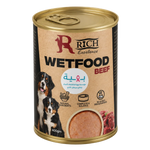 A can of Rich Excellence wet dog food, beef flavor, with a gold lid and base, and a beige label featuring a Bernese mountain dog and a photo of wet food. The label also contains Arabic text and icons indicating natural ingredients and complete balance.