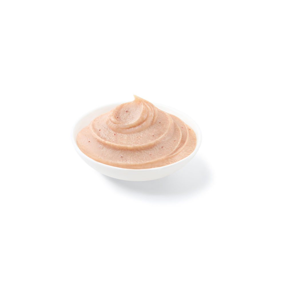 White bowl with a swirl of brown sauce on a white background