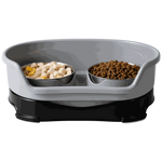 Pet feeding station with two bowls containing food on a white background