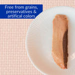 Beige food product on a white plate with a pink woven background and text about being grain-free, preservative-free, and color-free.