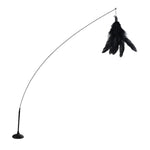 Black feathered cat toy on an arch-shaped stand against a white background